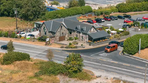 Bramley Lodge from above — the building and terrace umbrellas