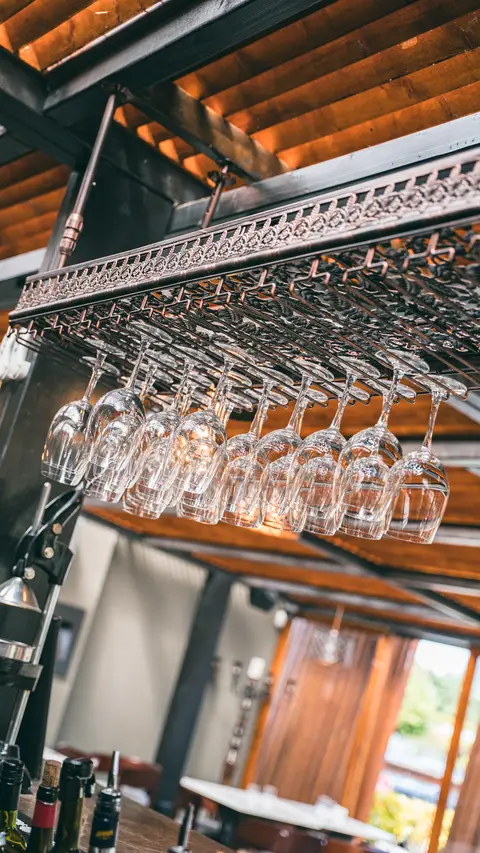 Glassware hanging above the bar under the timber ceiling