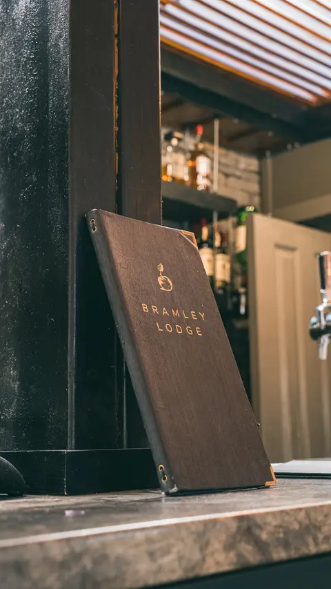 The Bramley Lodge menu standing on the marble bar top