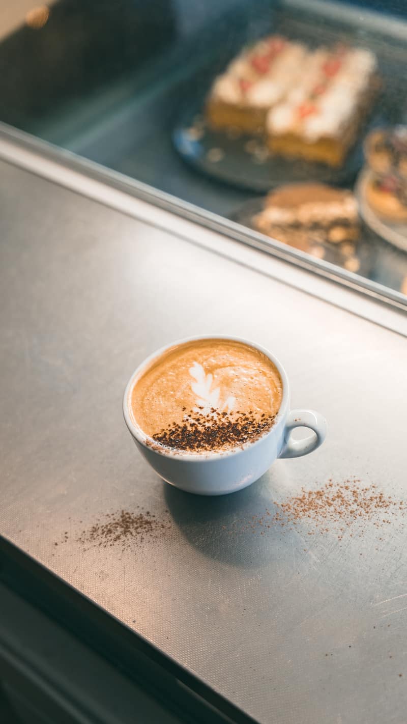 A cappuccino by the cake counter