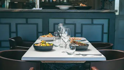 A table set for dinner in the dark-panelled dining room