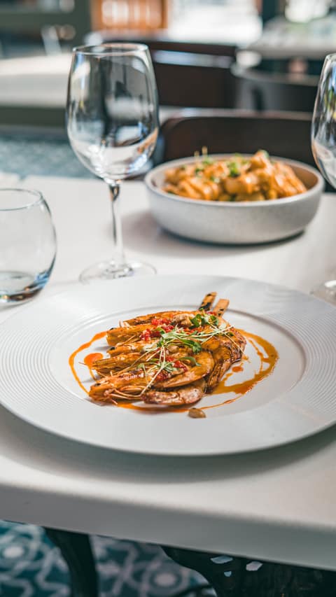 King prawns plated with dressing