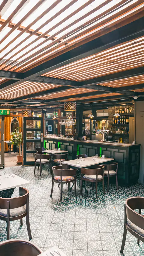 The orangery dining room, looking down the length of the bar