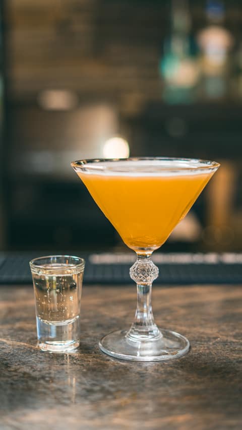 A pornstar martini with passion fruit and a shot on the side